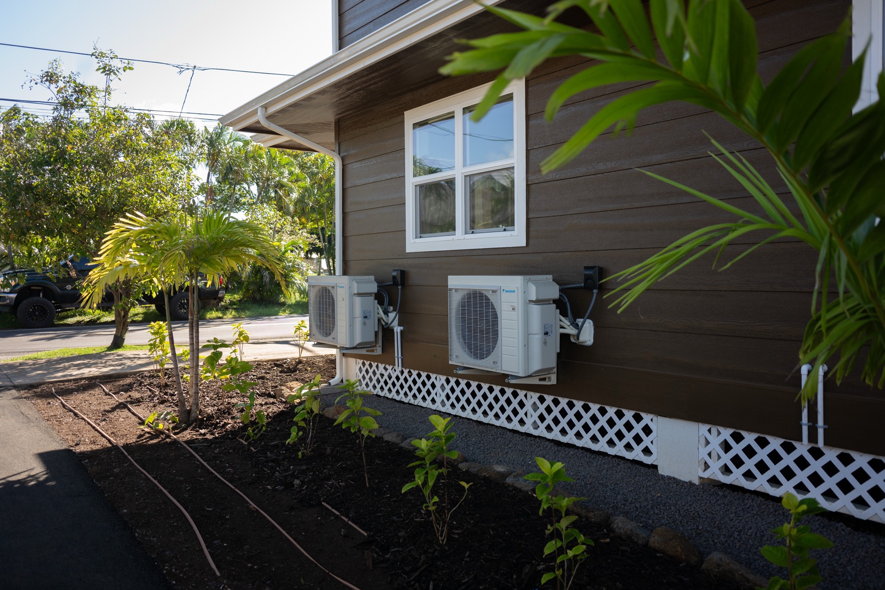 Mini split condenser units installed on a Hawaii home exterior